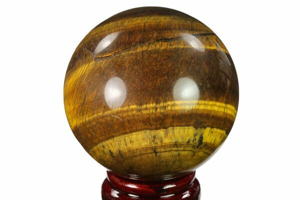 A polished stone sphere of Tiger's Eye.